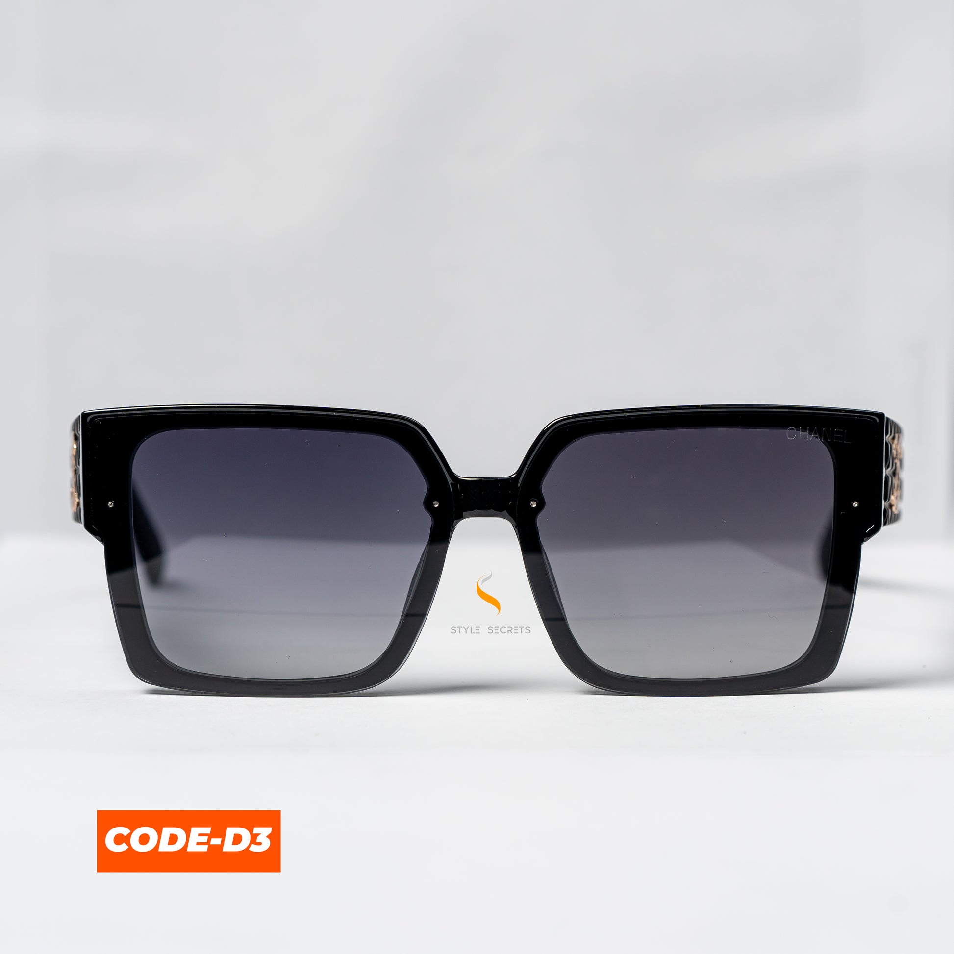 Chanel CODE-D3 sunglasses, showcasing a sleek, modern design with the iconic Chanel logo.


